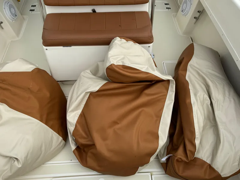 Slide: The Image of Brown and beige cushions on a 2004 Intrepid 32 Cuddy boat. - 18