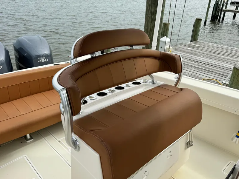Slide: The Image of 2004 Intrepid 32 Cuddy boat with brown leather seating and twin 250 engines. - 22