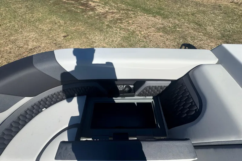 Slide: The Image of 2026 Sylvan L3 DLZ boat interior with open storage compartment, featuring modern design and upholstery. - 11