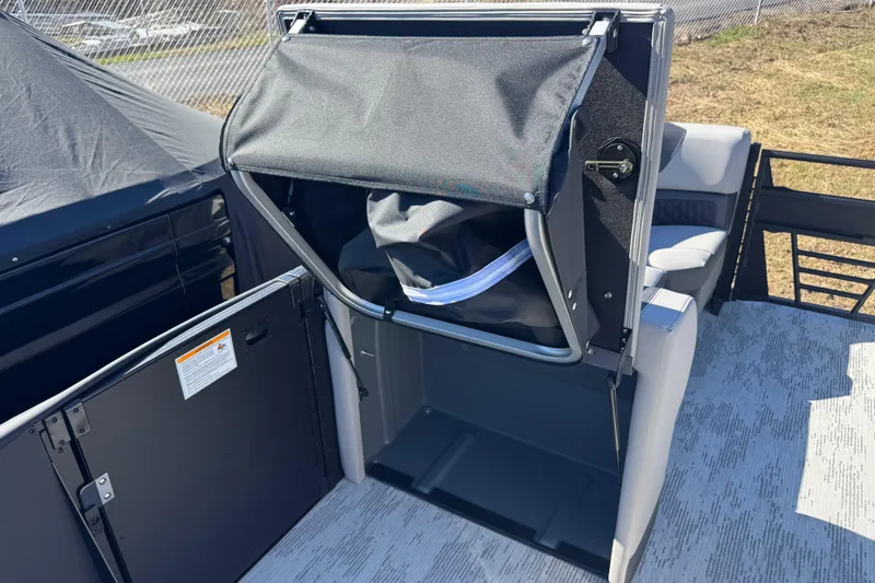 Slide: The Image of 2026 Sylvan L3 DLZ boat interior with storage compartment and seating area. - 14