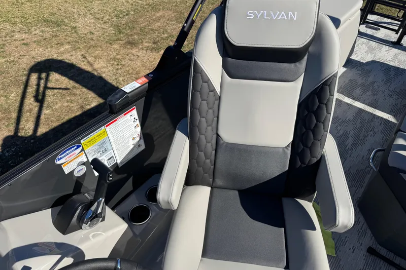 Slide: The Image of Captain's seat of 2026 Sylvan L3 DLZ boat with control panel and cup holders. - 15