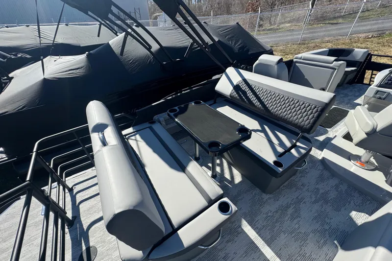 Slide: The Image of 2026 Sylvan L3 DLZ pontoon boat interior with gray seating and table. - 17