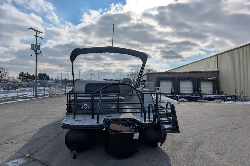 Slide: The Image of 2026 Sylvan L3 DLZ pontoon boat parked outdoors on a cloudy day. - 5