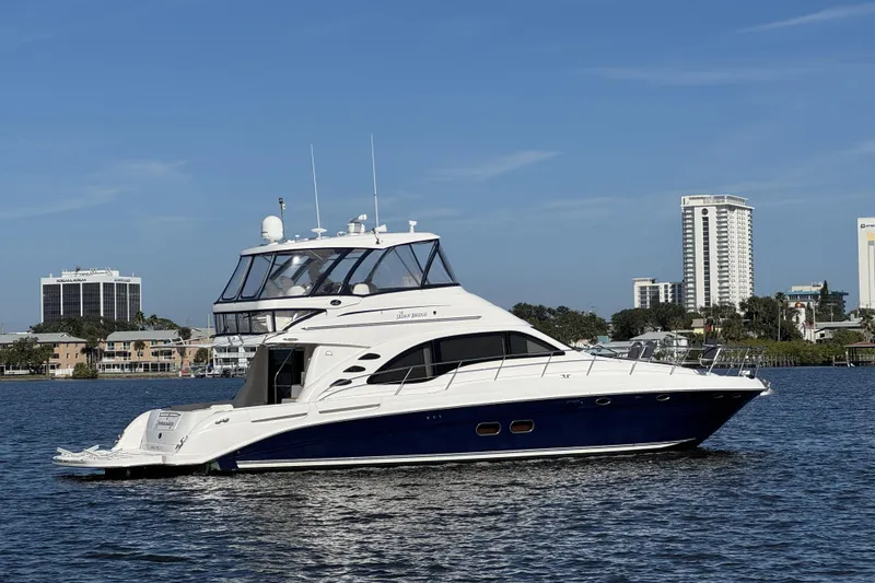 The Image of 2007 Sea Ray 58 Sedan Bridge yacht on water, cityscape background. - 0