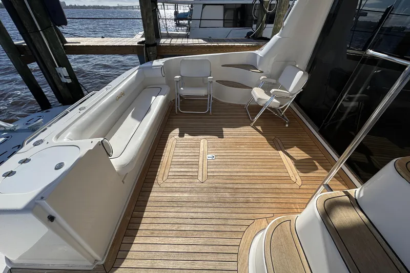 Slide: The Image of 2007 Sea Ray 58 Sedan Bridge yacht deck with seating and wooden flooring. - 14