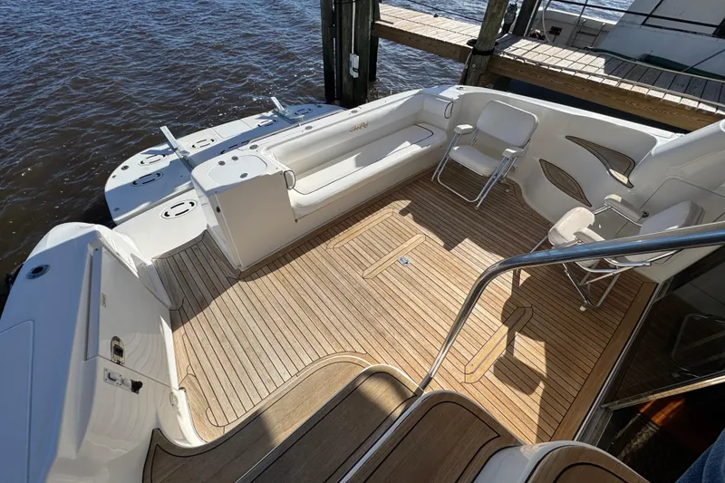 Slide: The Image of 2007 Sea Ray 58 Sedan Bridge yacht deck with wooden flooring and seating area. - 15