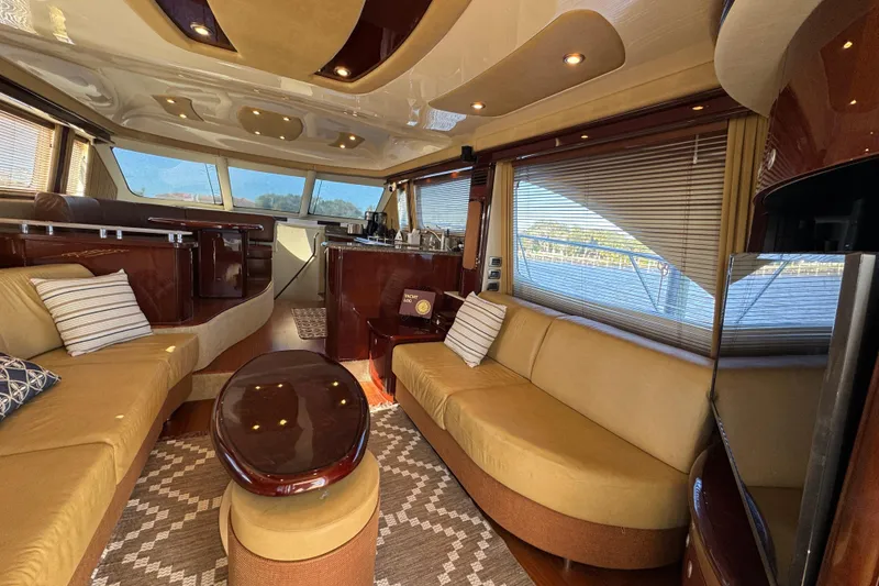 Slide: The Image of Luxurious interior of 2007 Sea Ray 58 Sedan Bridge yacht with elegant seating and panoramic windows. - 28