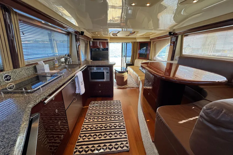 Slide: The Image of Luxurious interior of a 2007 Sea Ray 58 Sedan Bridge yacht with modern kitchen and seating area. - 30