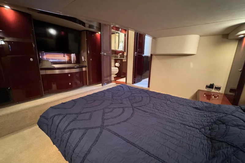 Slide: The Image of Luxurious bedroom interior of 2007 Sea Ray 58 Sedan Bridge yacht with elegant furnishings. - 44