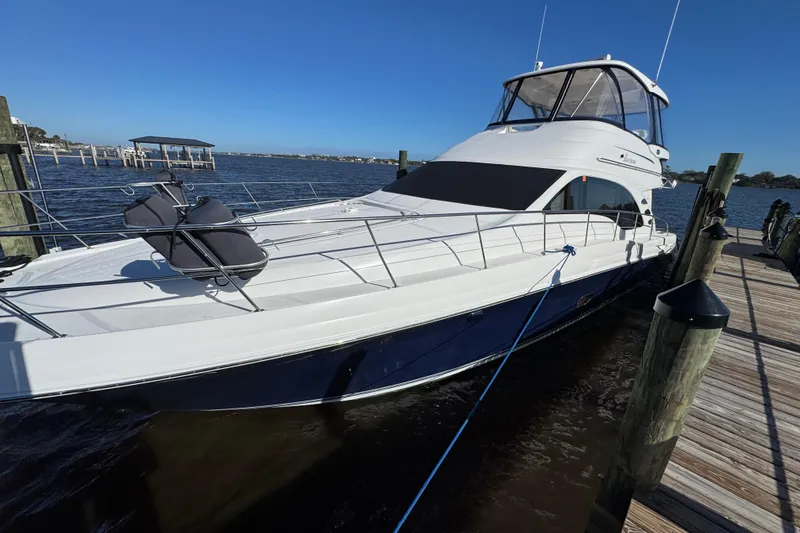 Slide: The Image of 2007 Sea Ray 58 Sedan Bridge yacht docked by the pier on a sunny day. - 5