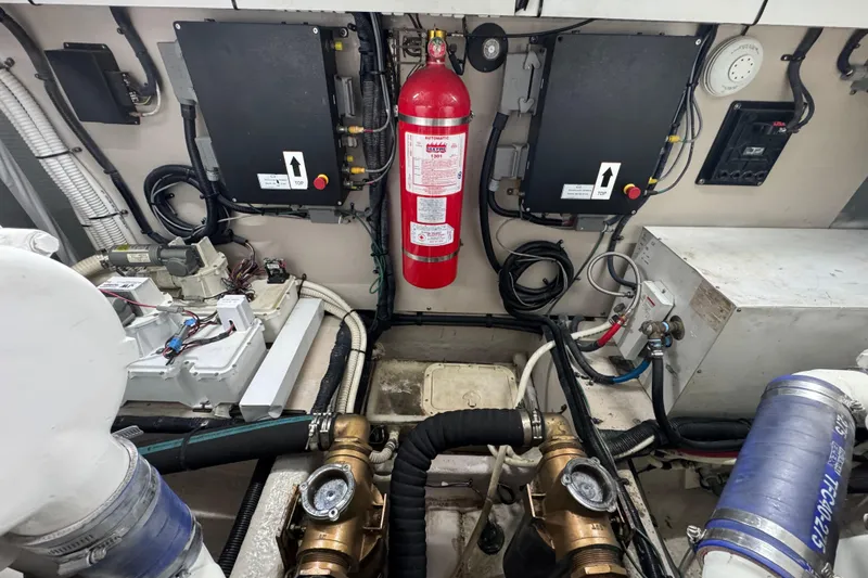 Slide: The Image of Engine room of 2007 Sea Ray 58 Sedan Bridge with fire extinguisher and mechanical components. - 57