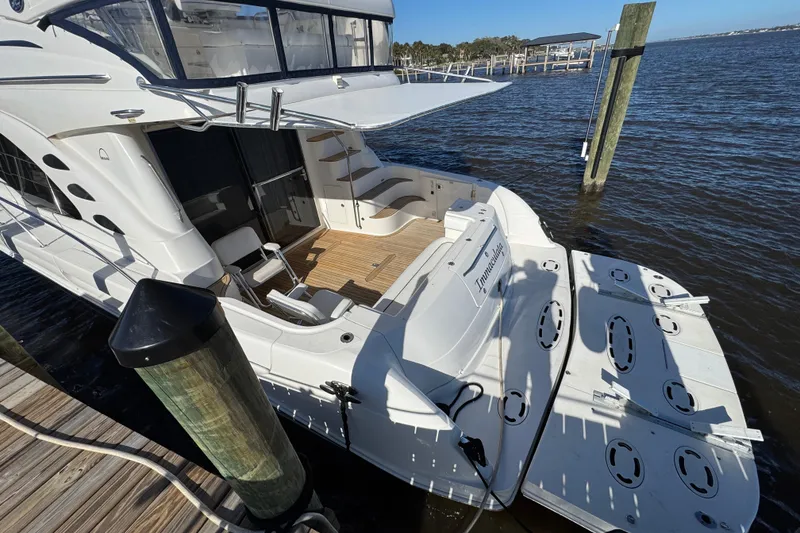 Slide: The Image of 2007 Sea Ray 58 Sedan Bridge yacht docked, featuring spacious deck and elegant design. - 12