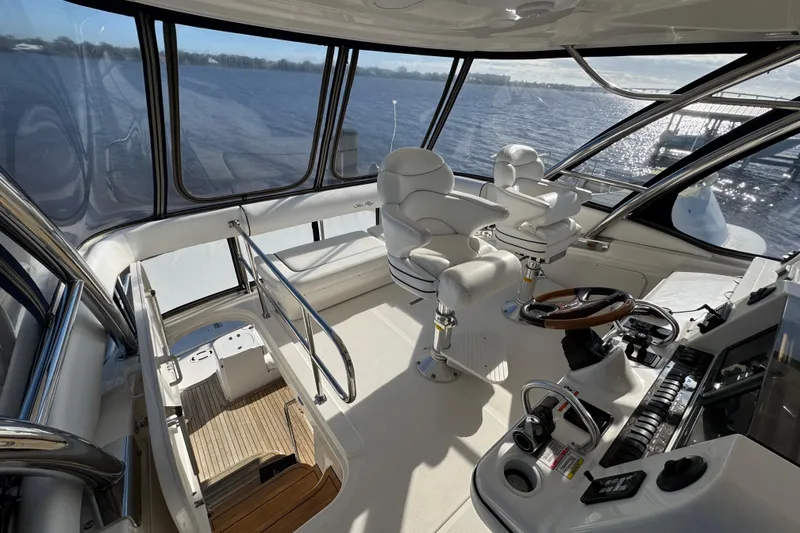 Slide: The Image of 2007 Sea Ray 58 Sedan Bridge helm with panoramic water views and luxurious seating. - 20