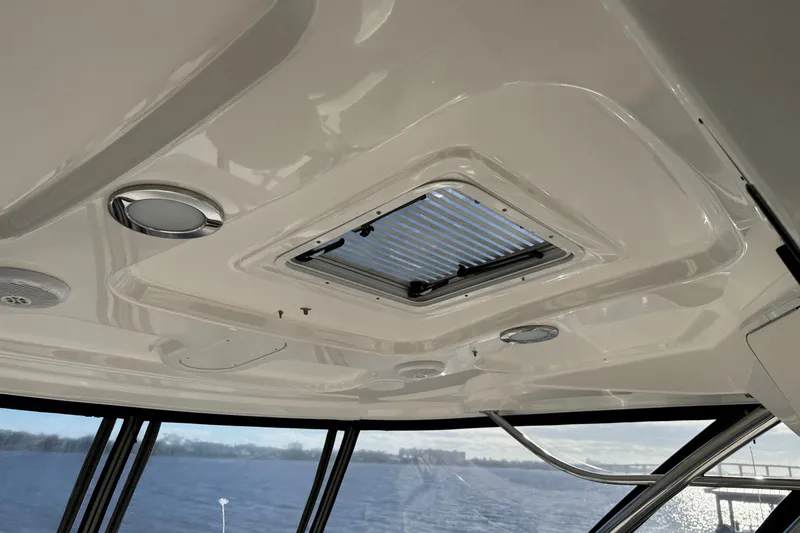 Slide: The Image of Ceiling view of 2007 Sea Ray 58 Sedan Bridge with hatch and lights. - 25