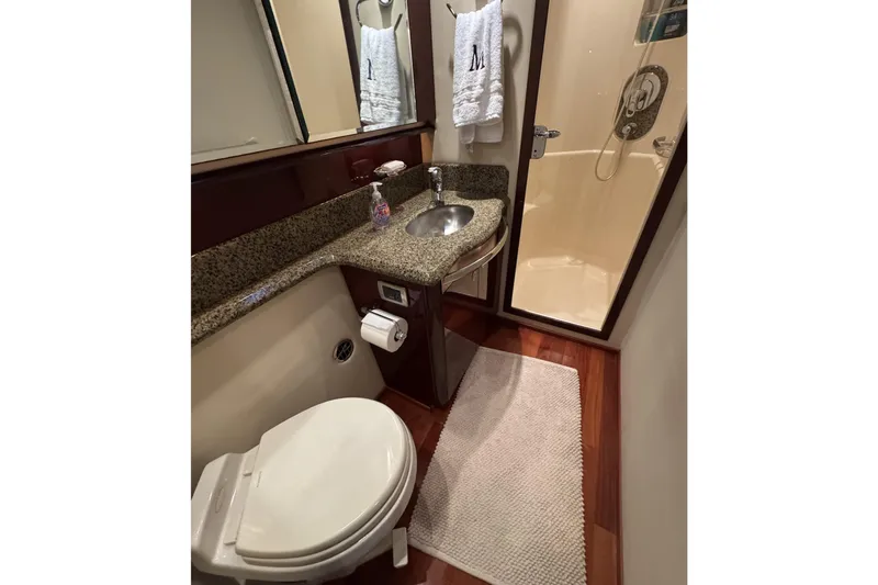 Slide: The Image of Luxurious bathroom in 2007 Sea Ray 58 Sedan Bridge yacht with granite countertop and shower. - 48