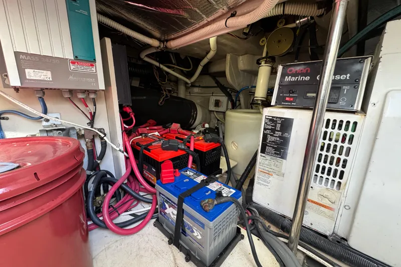 Slide: The Image of Engine room of 2007 Sea Ray 58 Sedan Bridge with batteries and marine generator. - 52