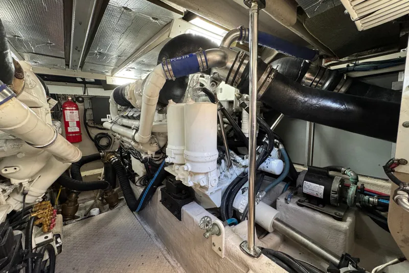 Slide: The Image of Engine room of 2007 Sea Ray 58 Sedan Bridge yacht, featuring complex machinery and equipment. - 55