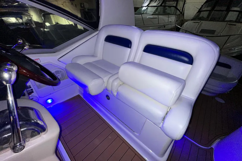 Slide: The Image of Interior of 2005 Sea Ray 320 Sundancer with white seating and blue ambient lighting. - 10