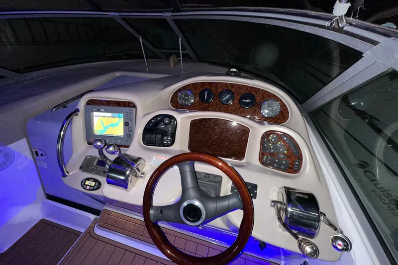 Slide: The Image of Helm of 2005 Sea Ray 320 Sundancer with navigation controls and steering wheel. - 11