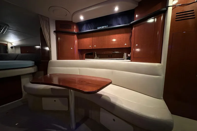 Slide: The Image of Interior of 2005 Sea Ray 320 Sundancer with elegant wood cabinetry and cozy seating area. - 13