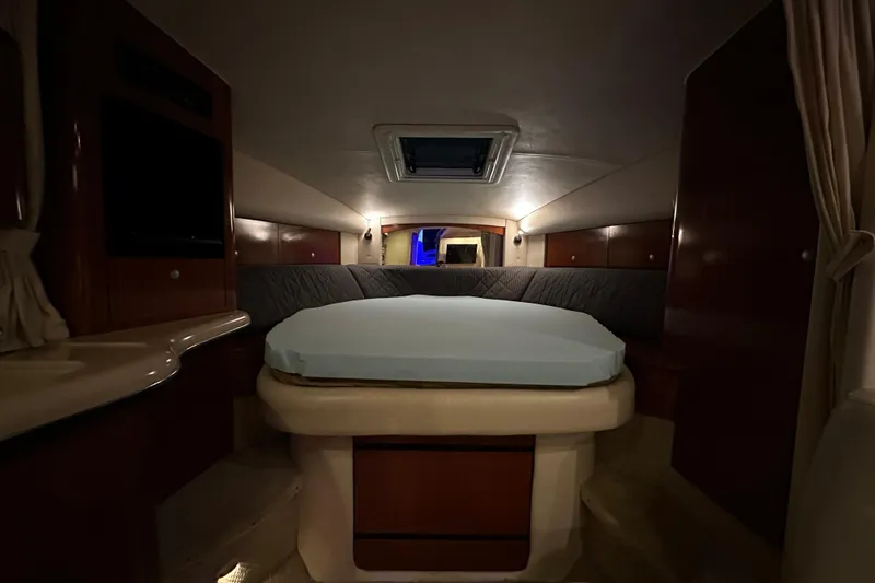 Slide: The Image of Interior cabin of 2005 Sea Ray 320 Sundancer with bed and wooden cabinetry. - 15