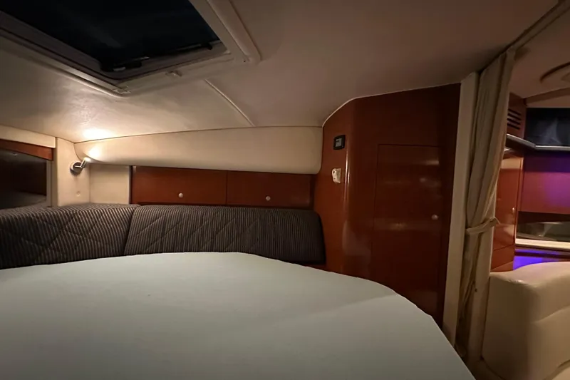 Slide: The Image of Interior cabin of 2005 Sea Ray 320 Sundancer with cozy seating and ambient lighting. - 17
