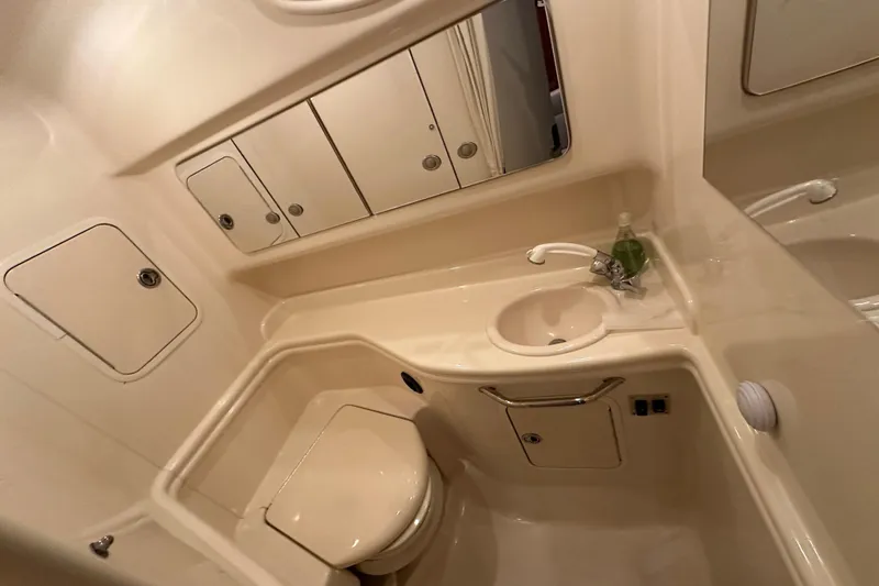 Slide: The Image of Bathroom interior of 2005 Sea Ray 320 Sundancer yacht, featuring sink and toilet. - 20