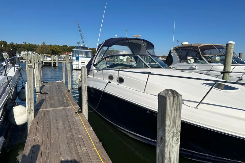 Slide: The Image of 2005 Sea Ray 320 Sundancer interior with blue LED lighting and white seating. - 4
