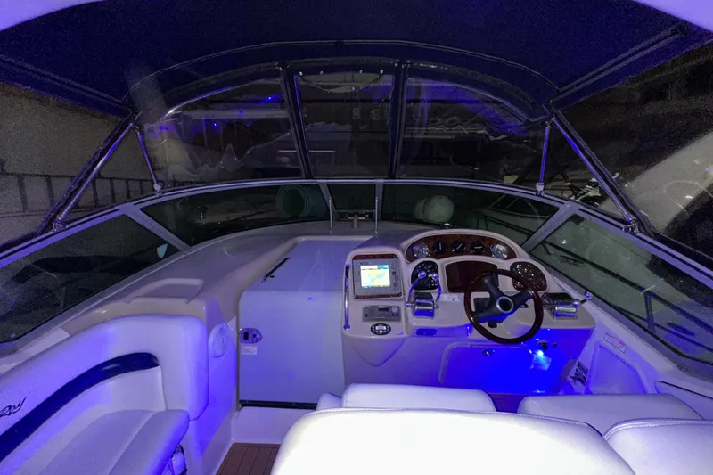 Slide: The Image of 2005 Sea Ray 320 Sundancer cockpit with illuminated dashboard and steering wheel. - 8