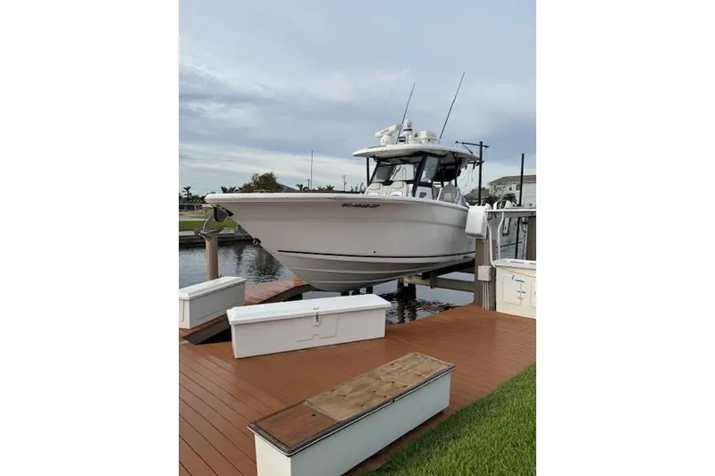 Slide: The Image of 2021 Sea Fox 368 Commander boat docked on wooden platform by the water. - 3