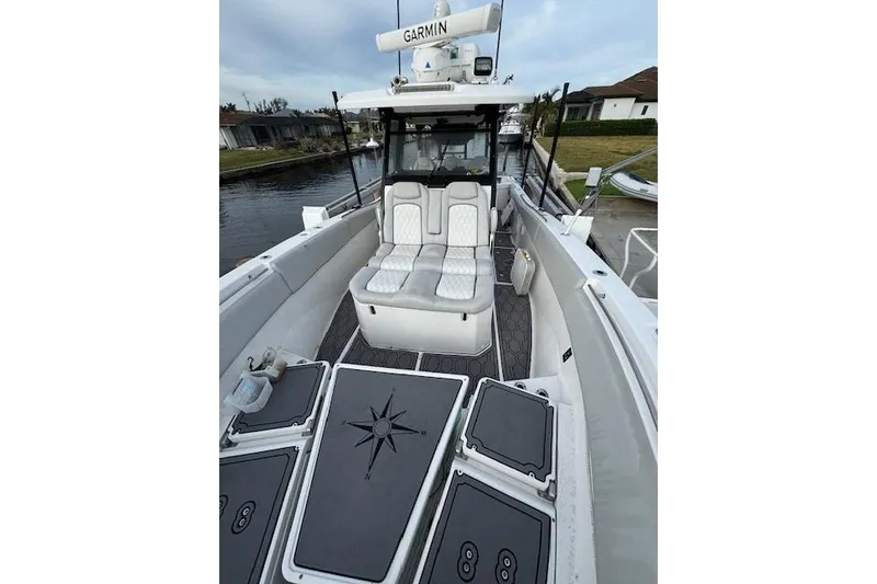 Slide: The Image of 2021 Sea Fox 368 Commander boat interior with cushioned seating and Garmin equipment. - 7