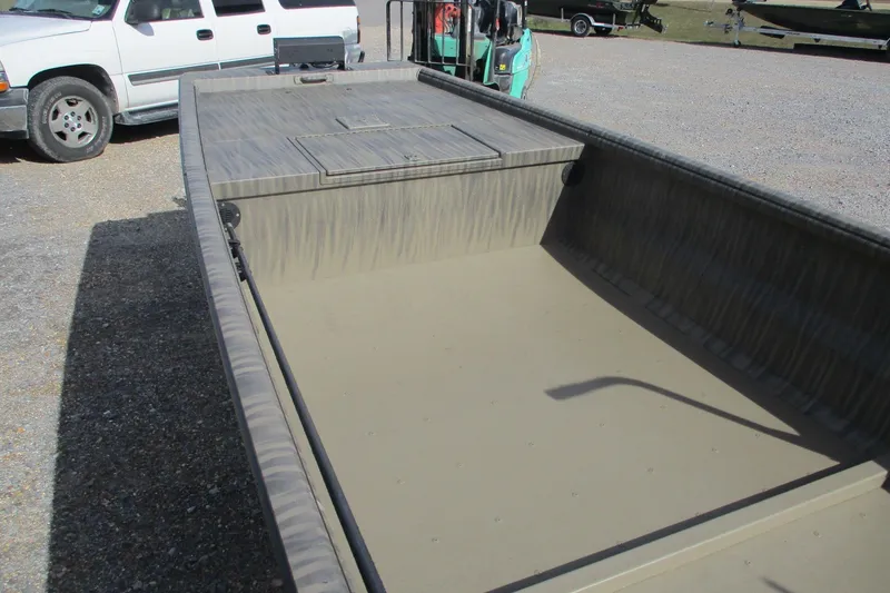 Slide: The Image of 2026 Gator Tail 1754 Extreme boat interior, parked on gravel near a white vehicle. - 6