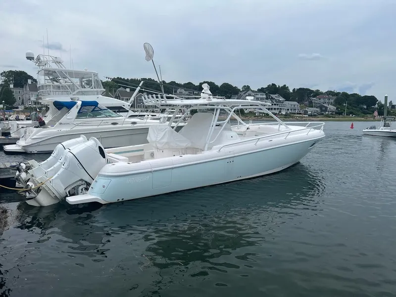The Image of 2018 Intrepid 375 Walkaround boat docked in a marina. - 0