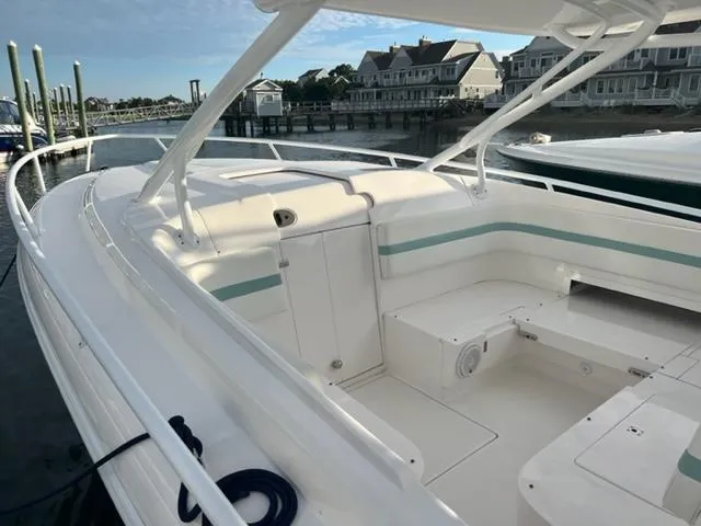 Slide: The Image of 2018 Intrepid 375 Walkaround boat docked at a marina with waterfront homes in the background. - 12