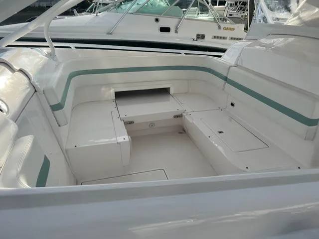 Slide: The Image of 2018 Intrepid 375 Walkaround boat interior with white and teal seating. - 14
