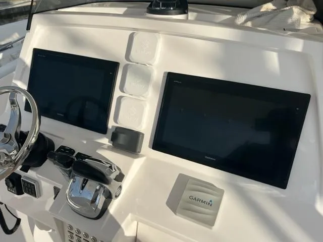 Slide: The Image of 2018 Intrepid 375 Walkaround helm with dual Garmin displays and controls. - 17