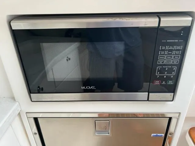 Slide: The Image of Built-in microwave and drawer in 2018 Intrepid 375 Walkaround boat kitchen. - 25