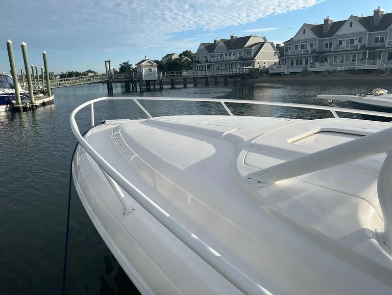 Slide: The Image of 2018 Intrepid 375 Walkaround boat docked near waterfront homes. - 3