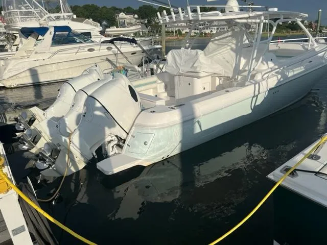 Slide: The Image of 2018 Intrepid 375 Walkaround boat docked at a marina. - 5