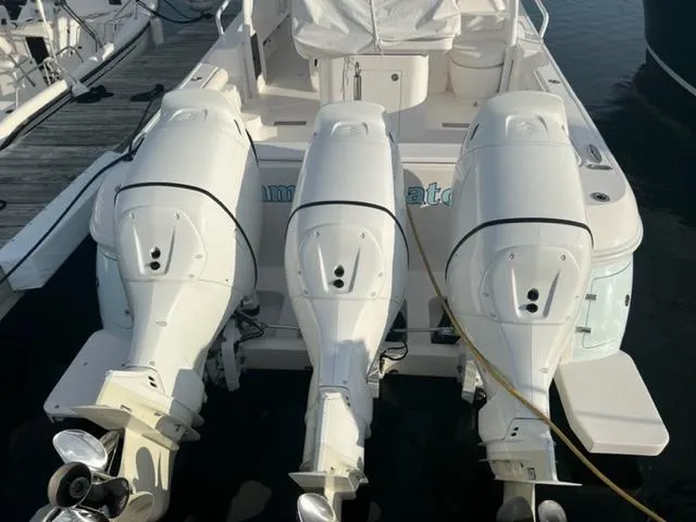 Slide: The Image of 2018 Intrepid 375 Walkaround with triple outboard engines docked. - 6