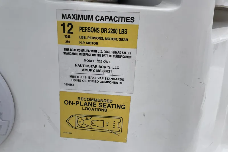 Slide: The Image of 2024 NauticStar 222L Offshore capacity label, 12 persons or 2200 lbs, safety compliance details. - 7