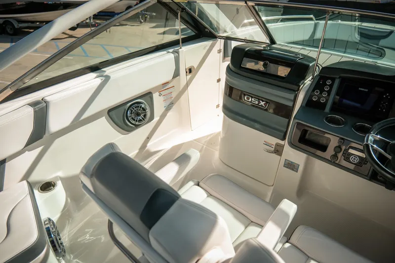 Slide: The Image of Interior of 2021 Chaparral 280 OSX boat, featuring modern helm and seating. - 17