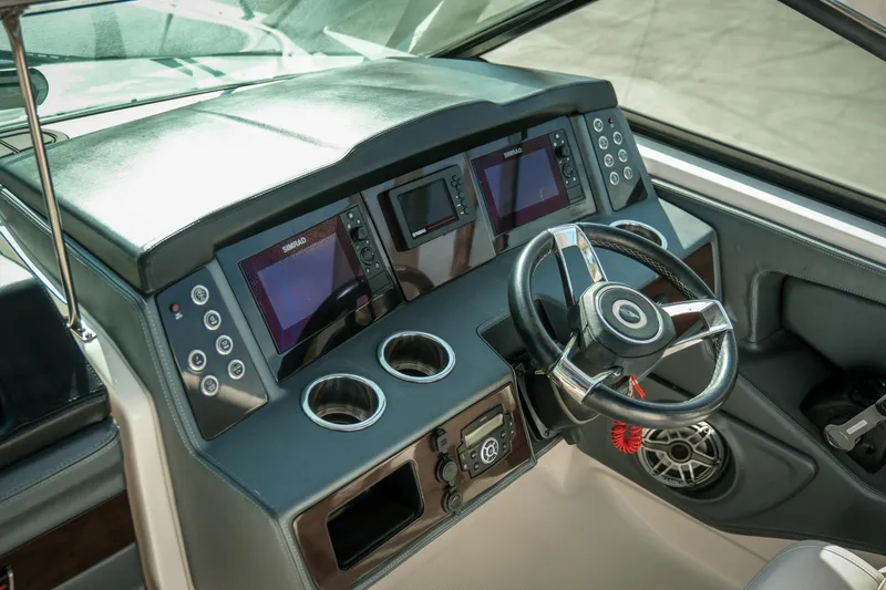 Slide: The Image of 2021 Chaparral 280 OSX boat dashboard with steering wheel and digital displays. - 20