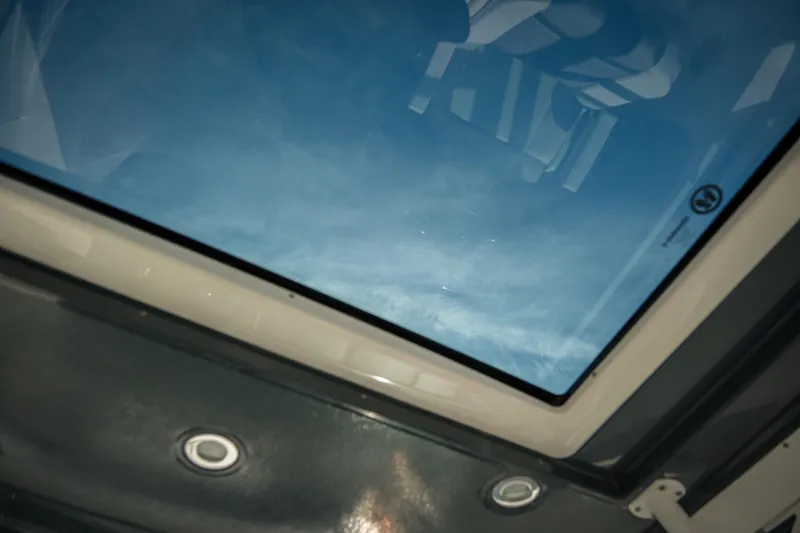 Slide: The Image of Skylight view from 2021 Chaparral 280 OSX boat interior, showcasing blue sky. - 27