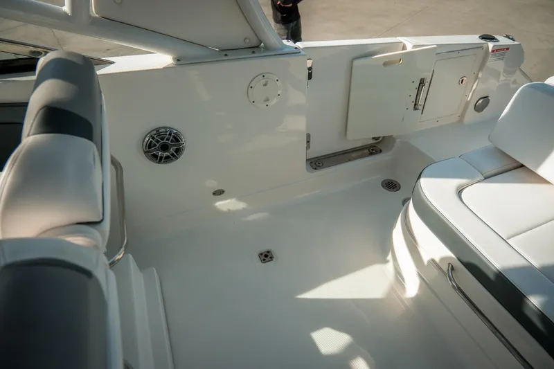 Slide: The Image of 2021 Chaparral 280 OSX boat interior with seating and storage compartments. - 28