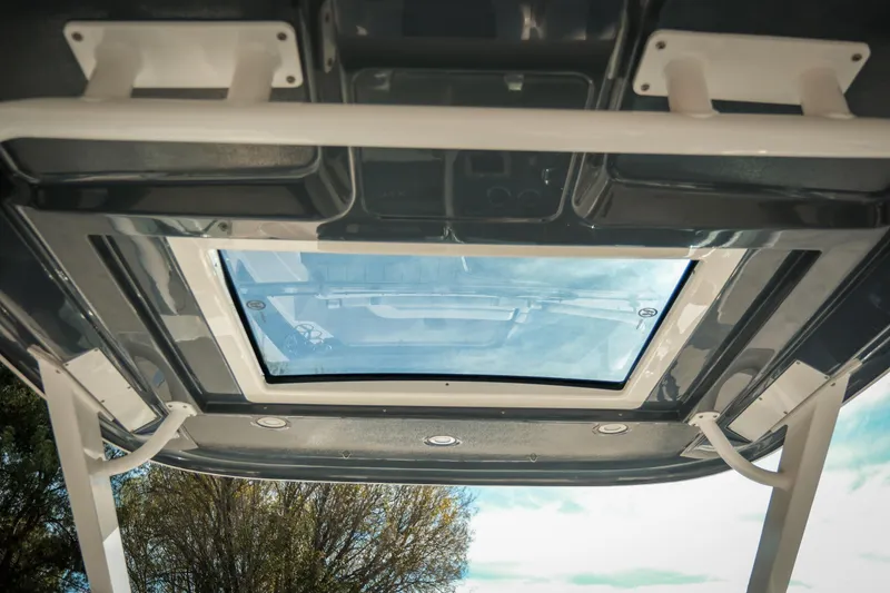 Slide: The Image of Rooftop view of 2021 Chaparral 280 OSX boat with glass sunroof and support beams. - 29