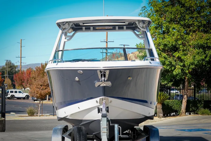 Slide: The Image of 2021 Chaparral 280 OSX boat on trailer, front view, outdoors. - 3