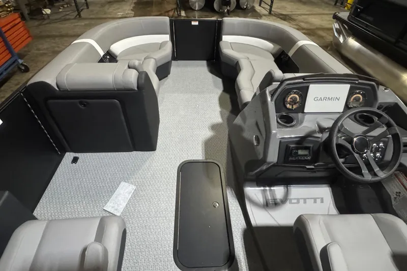 Slide: The Image of 2026 Evotti 521CS boat interior with modern seating and Garmin navigation system. - 14