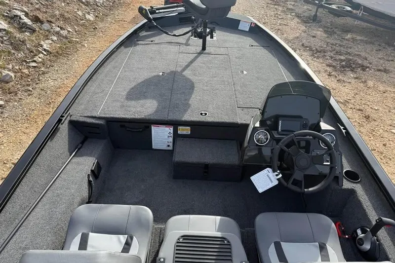 Slide: The Image of 2026 Lowe Stinger 195 Bass boat interior with steering console and seating. - 7