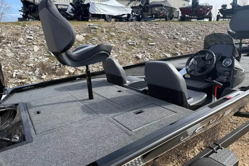 Slide: The Image of 2026 Lowe Stinger 195 Bass boat interior with seating and control panel. - 8